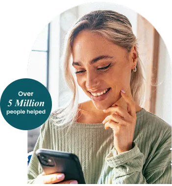 Person smiling while using their phone at home — Over 5 Million people helped